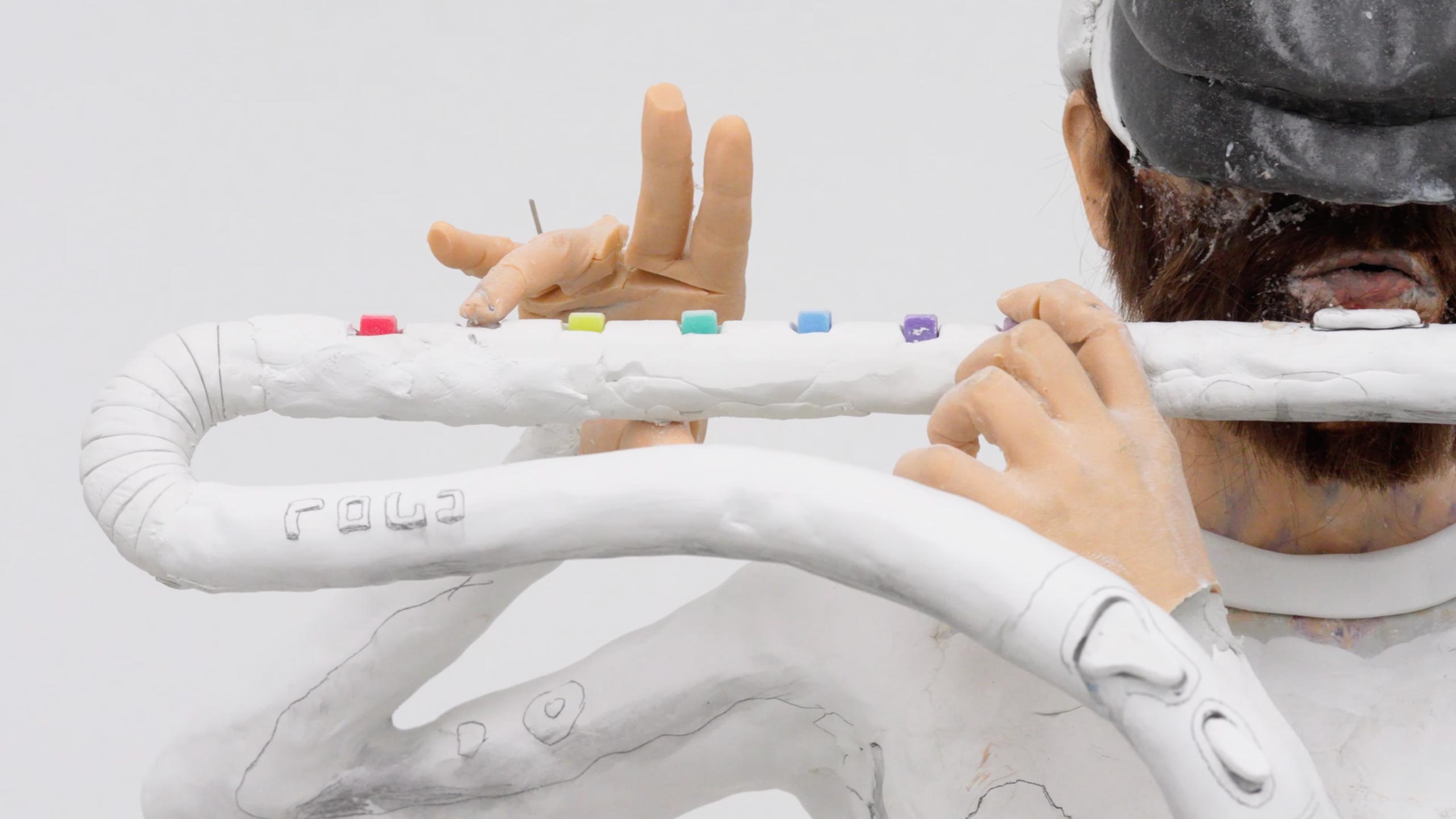A detail of a coloful sculpture by David Altmejd