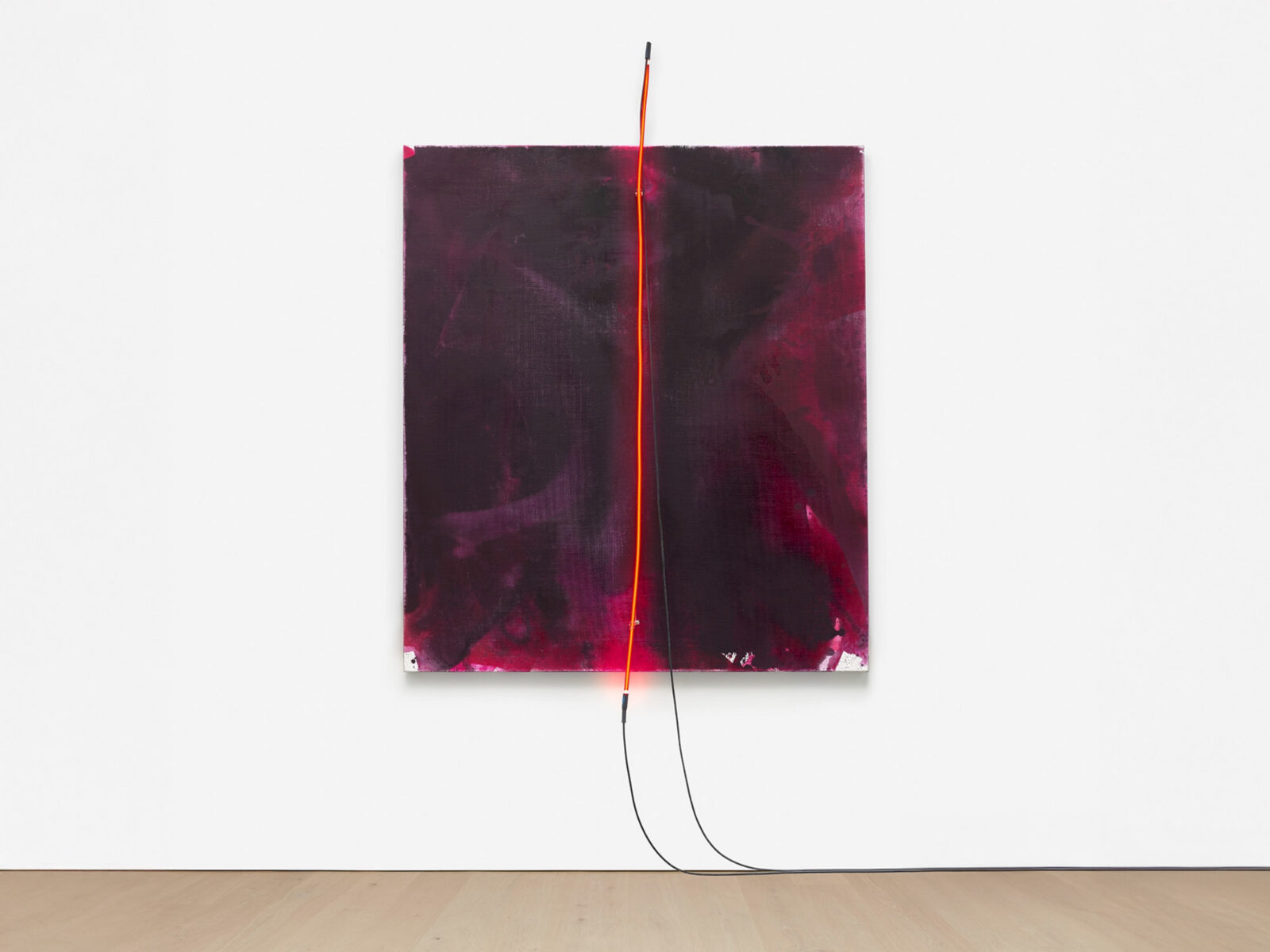 A dark-red abstract painting with a vertical red neon line in the front middle by the artist Mary Weatherford.